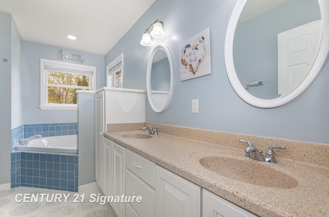 full bath with a sink, double vanity, a garden tub, and tile patterned floors