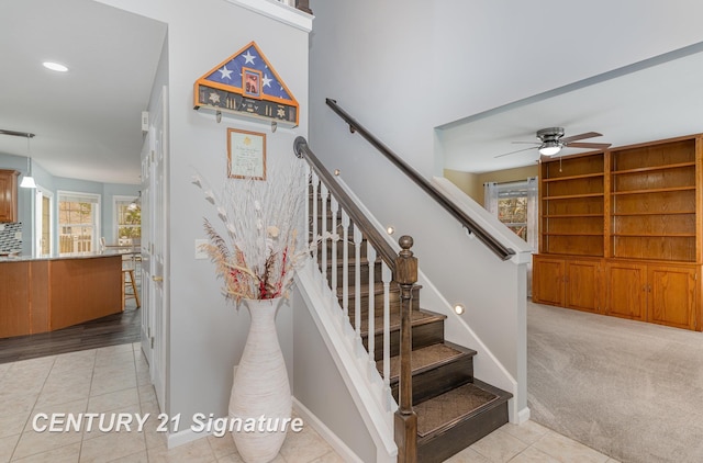 stairway with tile patterned flooring, a ceiling fan, a healthy amount of sunlight, and recessed lighting