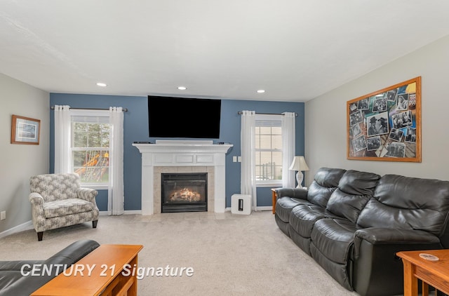 living room with recessed lighting, light carpet, and a tile fireplace