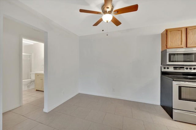 kitchen with appliances with stainless steel finishes, ceiling fan, and light tile patterned flooring