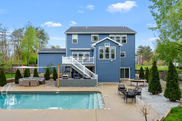 5849 Gavin Ln, Kalamazoo, MI 49009 - rear view of property featuring an outdoor hangout area, a wooden deck, a fenced in pool, and stairs