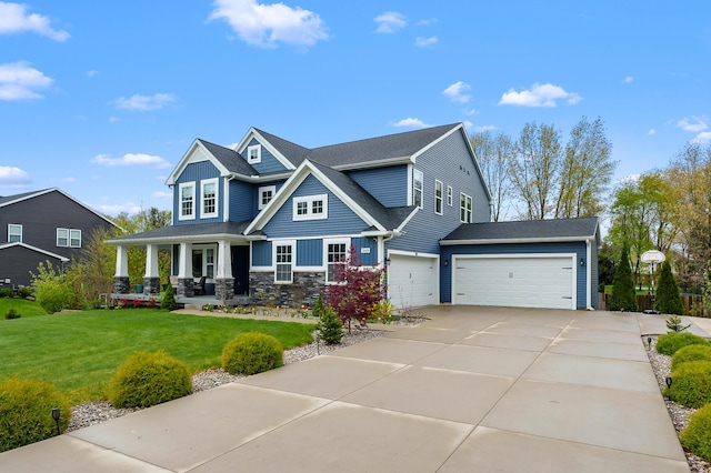 5849 Gavin Ln, Kalamazoo, MI 49009 - craftsman inspired home featuring covered porch, stone siding, a front lawn, board and batten siding, and driveway