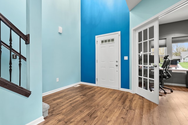 5849 Gavin Ln, Kalamazoo, MI 49009 - foyer featuring stairway, a towering ceiling, baseboards, and wood finished floors