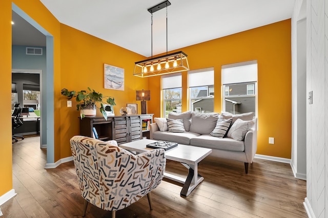 5849 Gavin Ln, Kalamazoo, MI 49009 - living room featuring wood-type flooring, a notable chandelier, baseboards, and visible vents