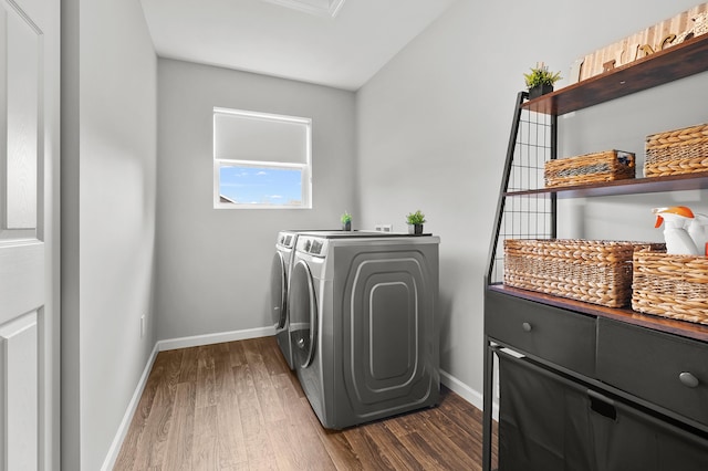 5849 Gavin Ln, Kalamazoo, MI 49009 - clothes washing area with baseboards, separate washer and dryer, laundry area, and dark wood-style floors