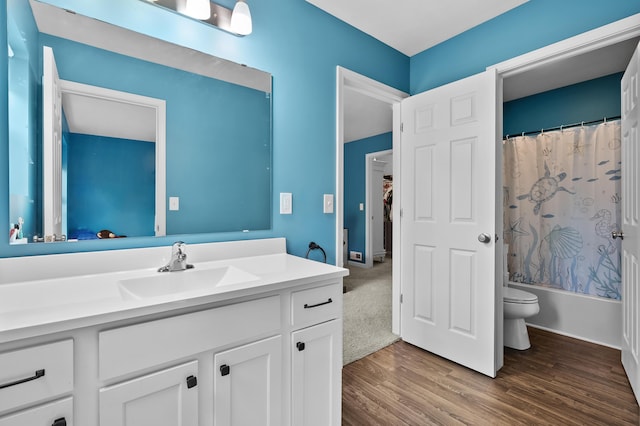 5849 Gavin Ln, Kalamazoo, MI 49009 - full bathroom featuring toilet, shower / tub combo with curtain, vanity, and wood finished floors