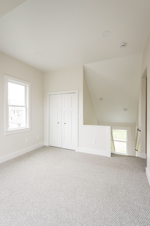 additional living space with carpet and baseboards