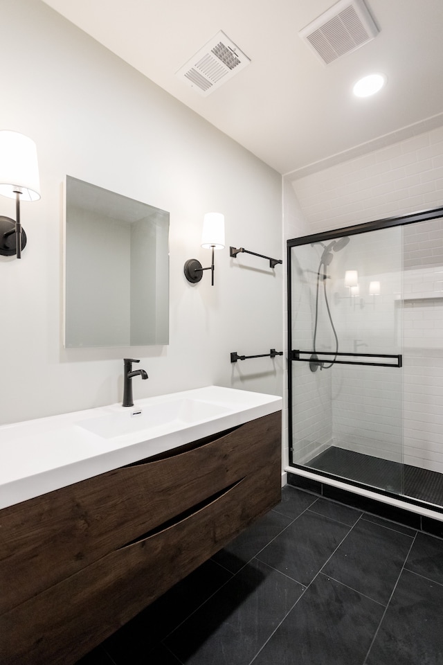 full bathroom with a stall shower, vanity, visible vents, and tile patterned floors