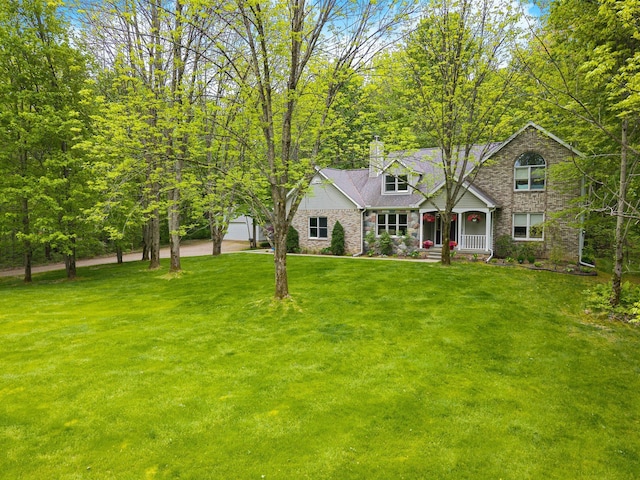 4217 Phillips Rd, Metamora, MI 48455 - view of front facade with a porch, a chimney, a front lawn, and stone siding