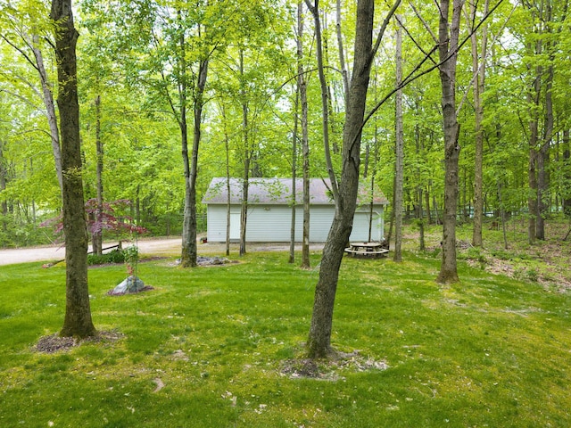 4217 Phillips Rd, Metamora, MI 48455 - view of green lawn featuring a garage and driveway