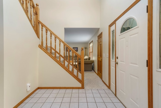 4217 Phillips Rd, Metamora, MI 48455 - foyer featuring stairs, baseboards, light tile patterned flooring, and a towering ceiling