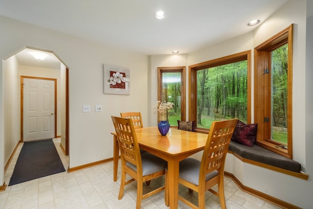 4217 Phillips Rd, Metamora, MI 48455 - dining space featuring arched walkways, baseboards, recessed lighting, and light floors