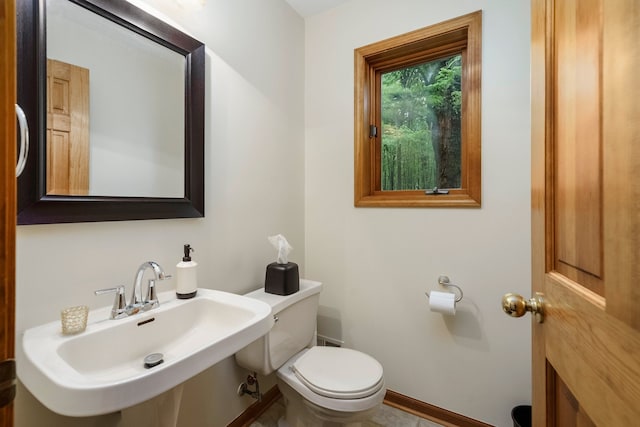 4217 Phillips Rd, Metamora, MI 48455 - bathroom featuring a sink, toilet, and baseboards