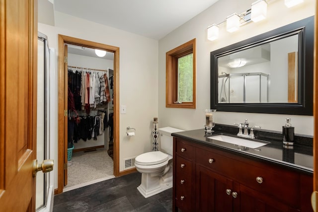 4217 Phillips Rd, Metamora, MI 48455 - full bathroom featuring a stall shower, vanity, toilet, and a walk in closet