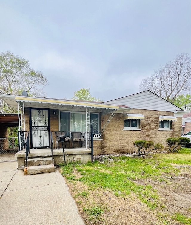 6507 Dupont St, Flint, MI 48505 - view of front of home featuring covered porch and an attached carport
