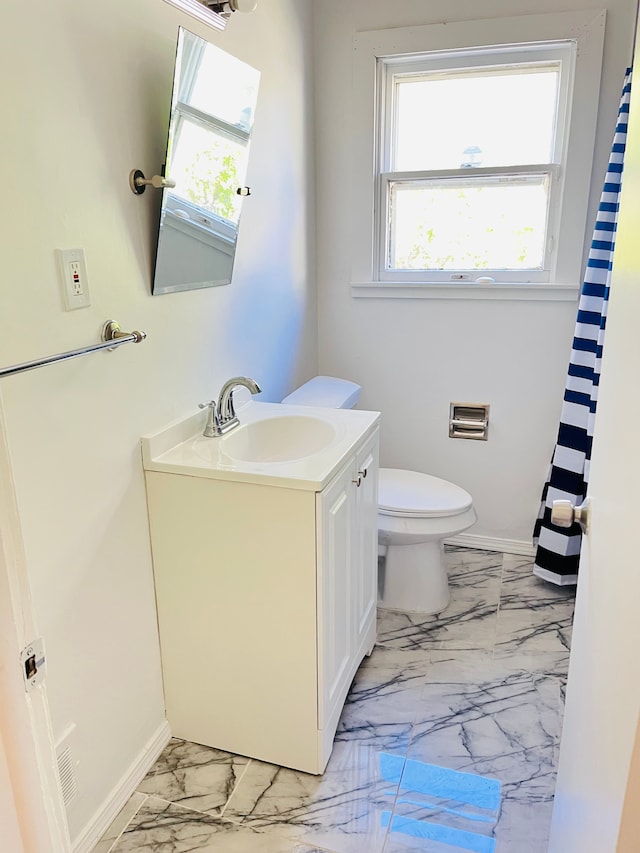 6507 Dupont St, Flint, MI 48505 - full bathroom featuring marble finish floors, plenty of natural light, vanity, and toilet