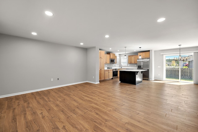 4125 Newton Rd, Commerce Twp, MI 48390 - kitchen with appliances with stainless steel finishes, open floor plan, recessed lighting, light countertops, and baseboards