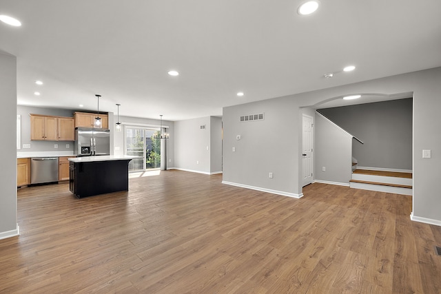 4125 Newton Rd, Commerce Twp, MI 48390 - unfurnished living room with recessed lighting, baseboards, light wood-style flooring, and stairs
