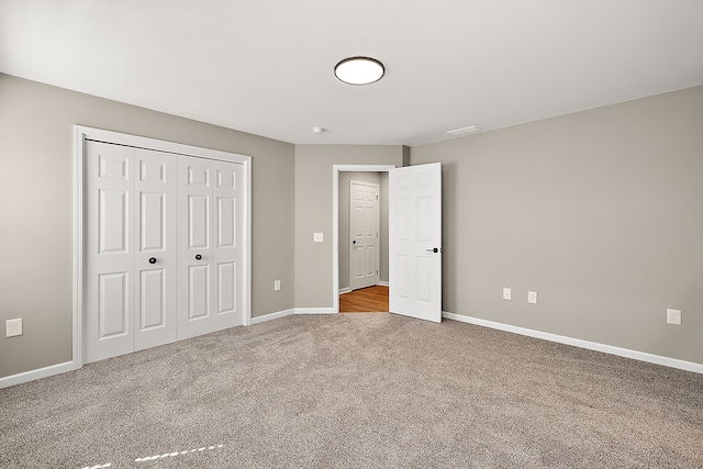 4125 Newton Rd, Commerce Twp, MI 48390 - unfurnished bedroom with carpet, baseboards, and a closet