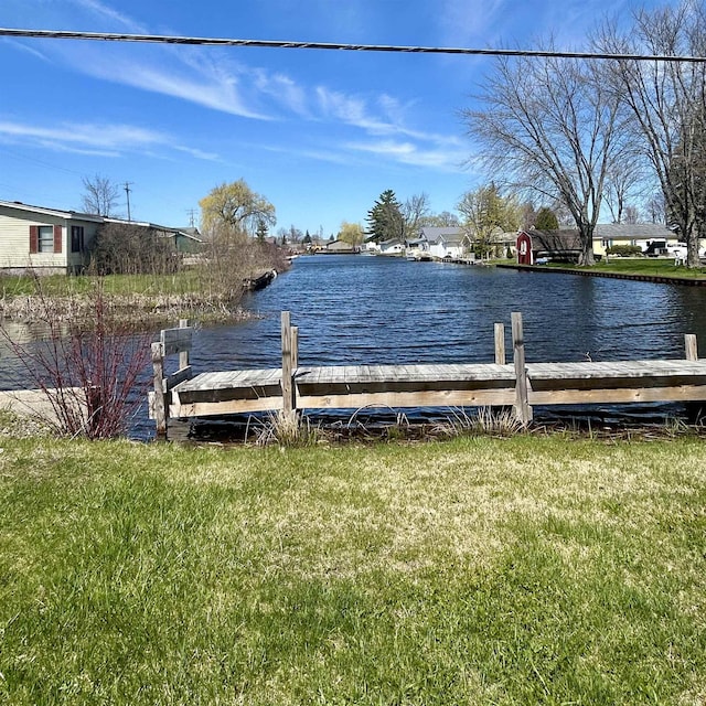 8874 W Houghton Lake Dr, Houghton Lake, MI 48629 - view of dock featuring a yard and a water view