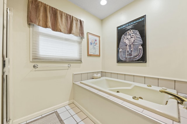 full bathroom featuring tile patterned flooring, baseboards, and a bath