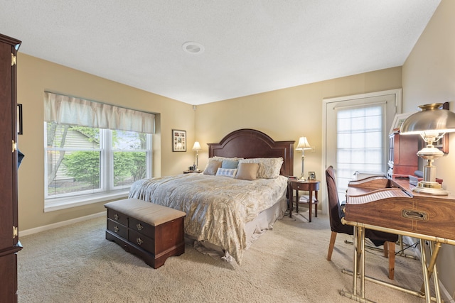 bedroom with multiple windows, light carpet, and baseboards