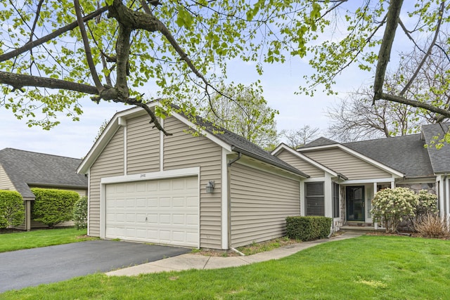 ranch-style house featuring a front lawn, a shingled roof, a garage, and aphalt driveway