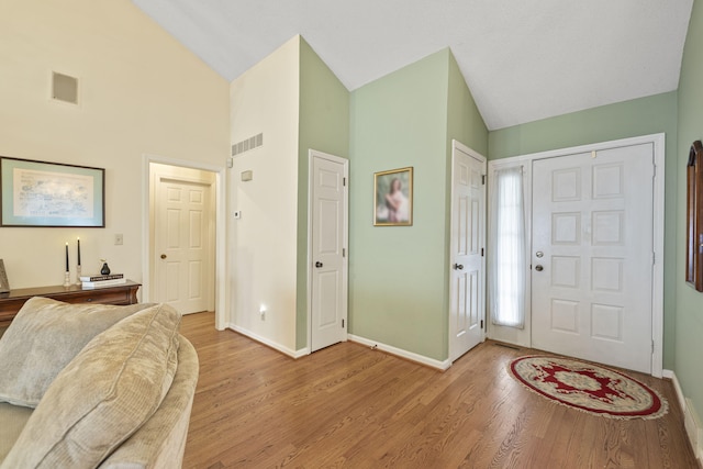 foyer featuring baseboards, visible vents, and light wood-style floors
