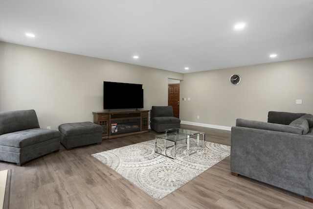 living area with wood finished floors, recessed lighting, and baseboards
