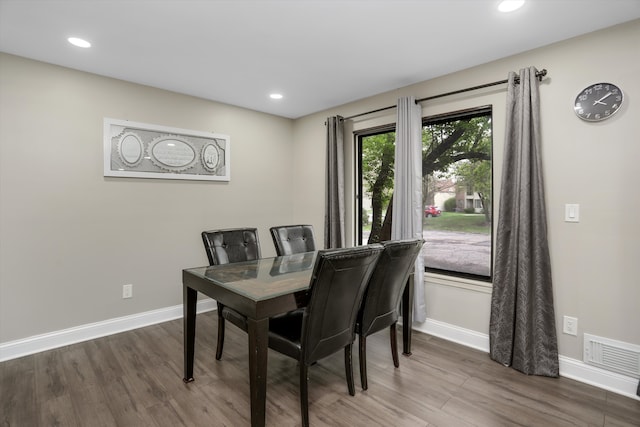 dining room with wood finished floors, baseboards, and recessed lighting