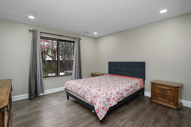 bedroom featuring wood finished floors, baseboards, and recessed lighting