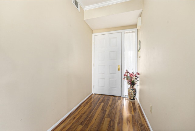 doorway with dark wood-style flooring, crown molding, baseboards, and visible vents