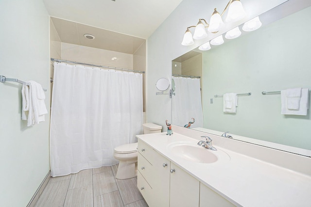 bathroom with toilet, vanity, and a shower with shower curtain