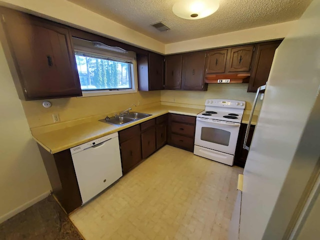 854 Kelley St, Traverse City, MI 49686 - kitchen with white appliances, a sink, under cabinet range hood, dark brown cabinets, and a textured ceiling