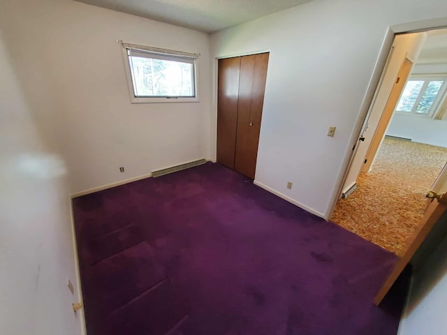 854 Kelley St, Traverse City, MI 49686 - unfurnished bedroom featuring dark colored carpet, multiple windows, and baseboards