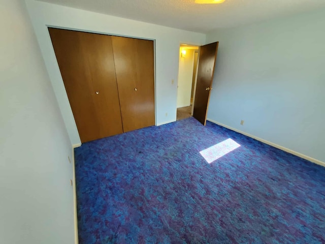 854 Kelley St, Traverse City, MI 49686 - unfurnished bedroom with a closet, carpet floors, and baseboards