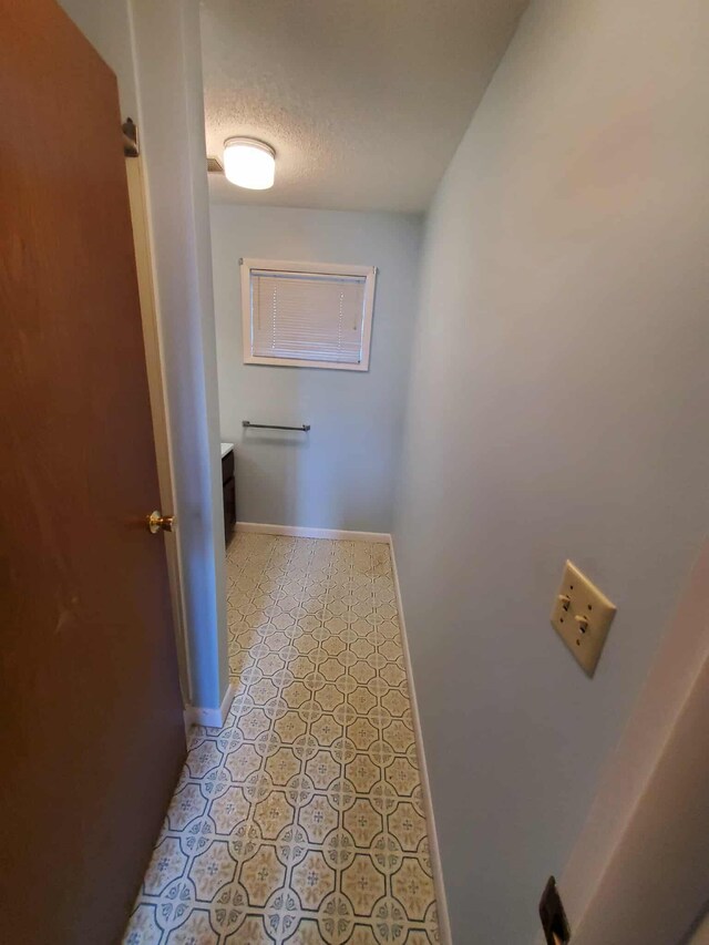 854 Kelley St, Traverse City, MI 49686 - hallway with a textured ceiling and baseboards