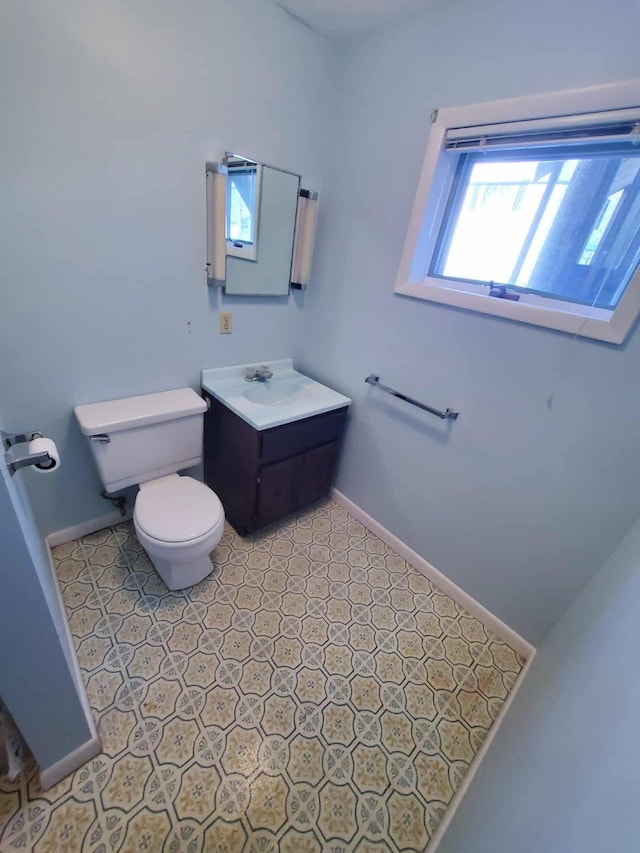 854 Kelley St, Traverse City, MI 49686 - half bathroom featuring toilet, baseboards, and vanity