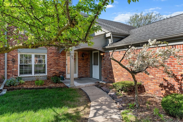 2658 Williamsburg Cir Unit 47, Auburn Hills, MI 48326 - property entrance featuring a shingled roof and brick siding