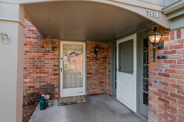 2658 Williamsburg Cir Unit 47, Auburn Hills, MI 48326 - doorway to property with brick siding and covered porch