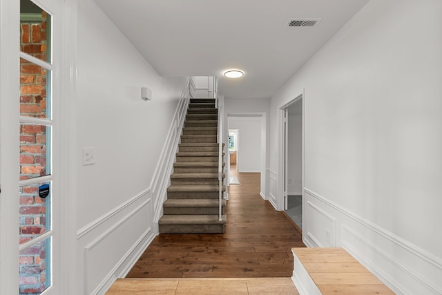 2658 Williamsburg Cir Unit 47, Auburn Hills, MI 48326 - staircase with a decorative wall, wainscoting, and wood finished floors