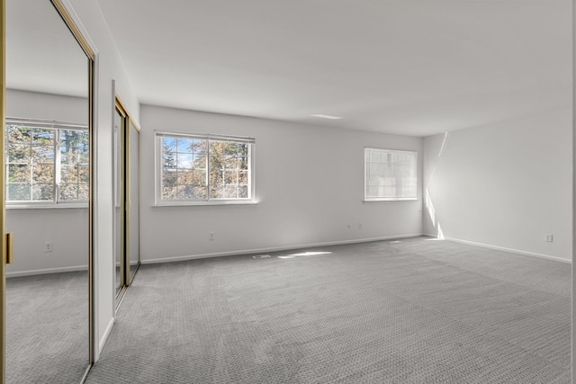 2658 Williamsburg Cir Unit 47, Auburn Hills, MI 48326 - unfurnished bedroom with carpet floors, multiple windows, and baseboards