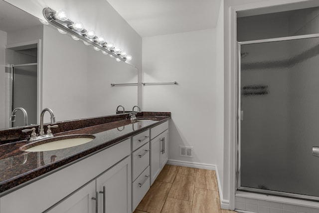2658 Williamsburg Cir Unit 47, Auburn Hills, MI 48326 - full bathroom featuring a stall shower, double vanity, and baseboards