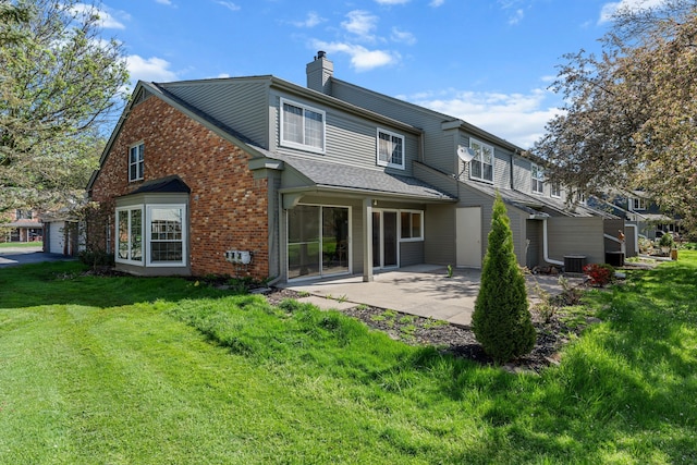 2658 Williamsburg Cir Unit 47, Auburn Hills, MI 48326 - rear view of property with central AC, brick siding, a chimney, a lawn, and a patio area