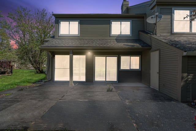2658 Williamsburg Cir Unit 47, Auburn Hills, MI 48326 - view of front facade with a chimney, roof with shingles, a patio area, and a front yard