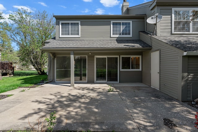 2658 Williamsburg Cir Unit 47, Auburn Hills, MI 48326 - back of property with a patio, a chimney, roof with shingles, and a lawn