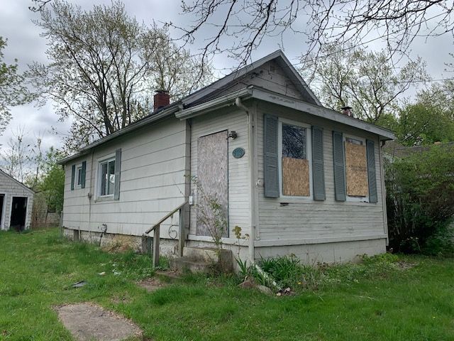 view of property exterior with a yard and a chimney
