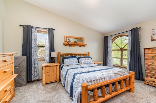 bedroom with vaulted ceiling and light carpet