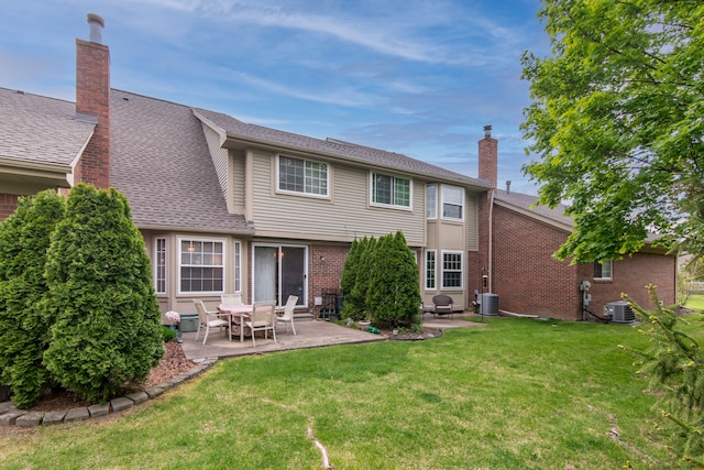 back of property featuring a patio area, brick siding, a lawn, and central AC