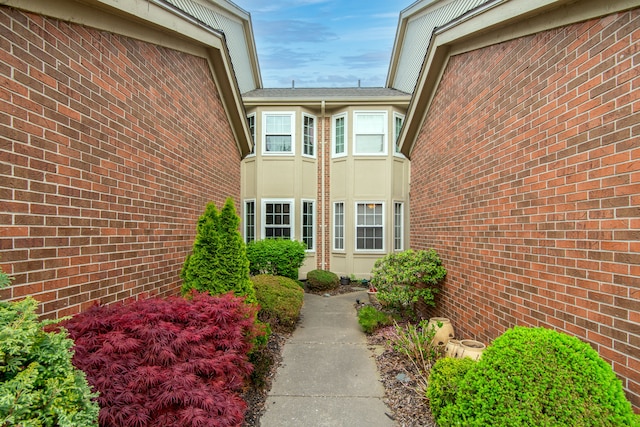 doorway to property featuring brick siding